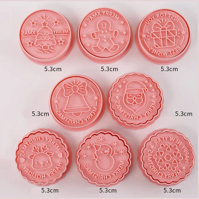 Set of pink Christmas-themed cookie stamps on a white background