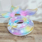 Inflatable ring with mermaid tail design on a wooden surface