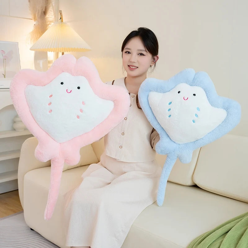 Woman holding Kawaii manta ray plushies