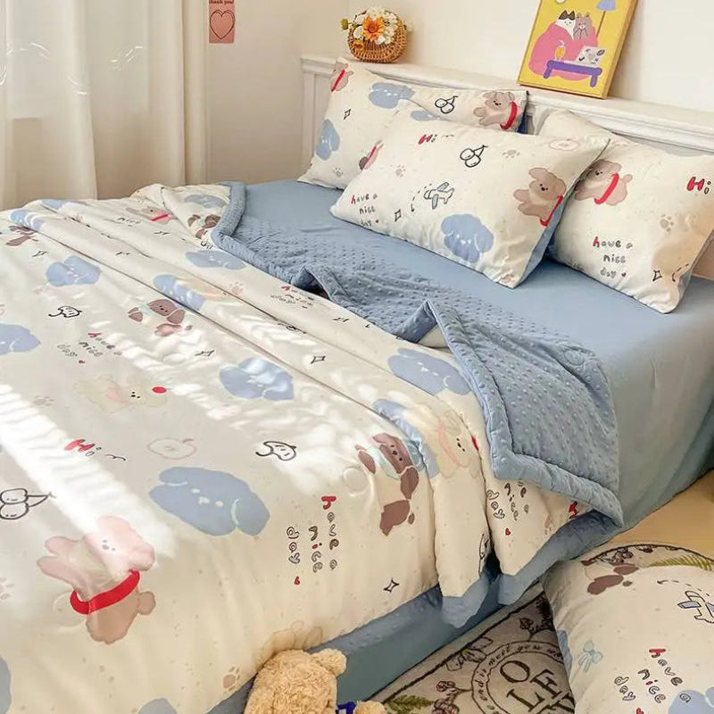 Kawaii Spring Quilts this is the Cute Brown Dog Design with Blue, it is displayed as a set on a bed.