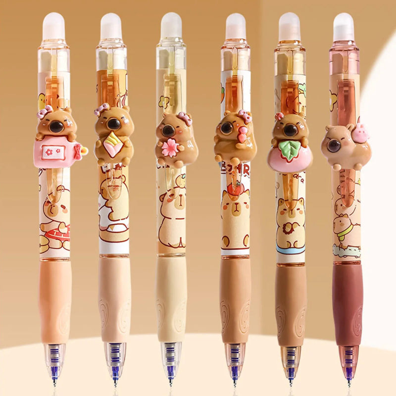 Set of sixcapybara-themed pens on a beige background