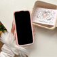 Front view of Kawaii Peach iPhone Case over a countertop held by a woman. 