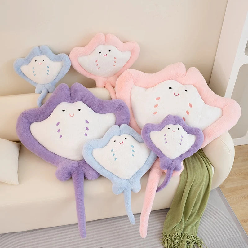 Kawaii manta ray plushies on couch