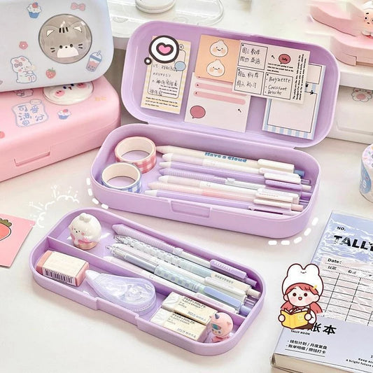 Purple stationery case with pens, markers, and small items on a white surface