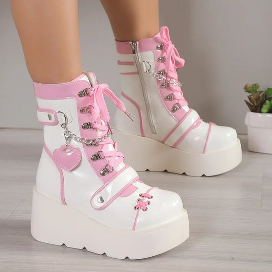 White and pink platform boots with decorative elements on a neutral background