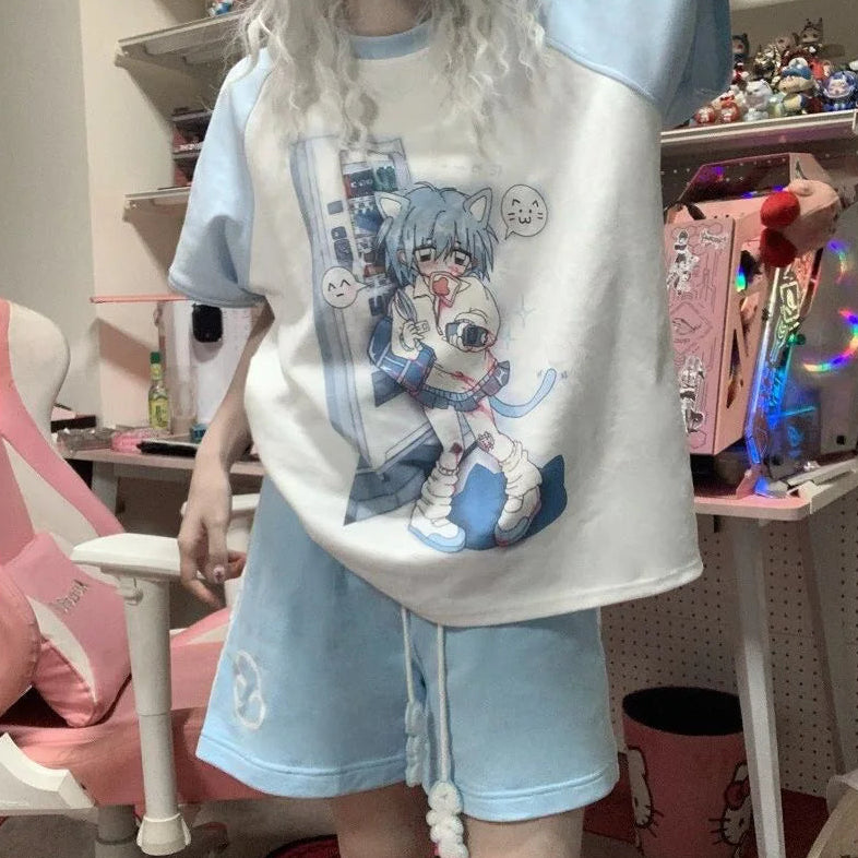 A person wearing a light blue and white graphic t-shirt with a large anime-style character print, paired with matching light blue shorts, standing in a room with shelves and a pink chair.
