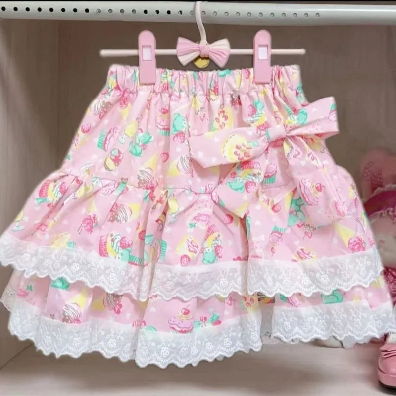 Pink skirt with floral pattern and lace trim on a hanger.