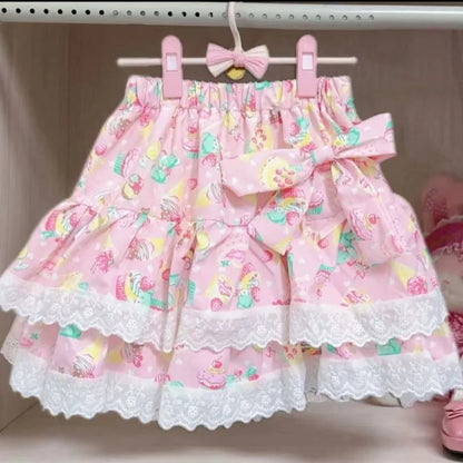 Pink skirt with floral pattern and lace trim on a hanger.