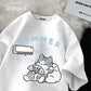 White t shirt with a kawaii cat and air conditioner graphic on a textured surface.