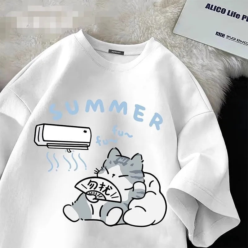 White t shirt with a kawaii cat and air conditioner graphic on a textured surface.