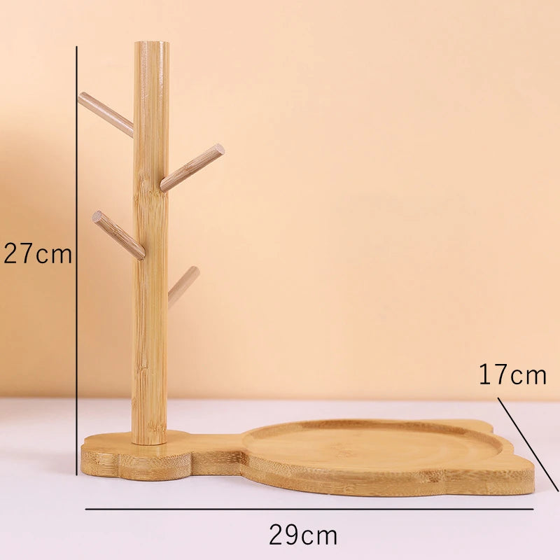 Wooden stand with hooks and a tray, measurements indicated, on a beige background