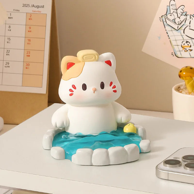 Cute cat-shaped figurine on a desk with a calendar and lamp in the background