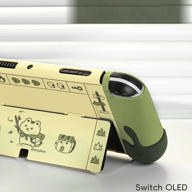 Green and beige gaming console with cartoon designs on a white background