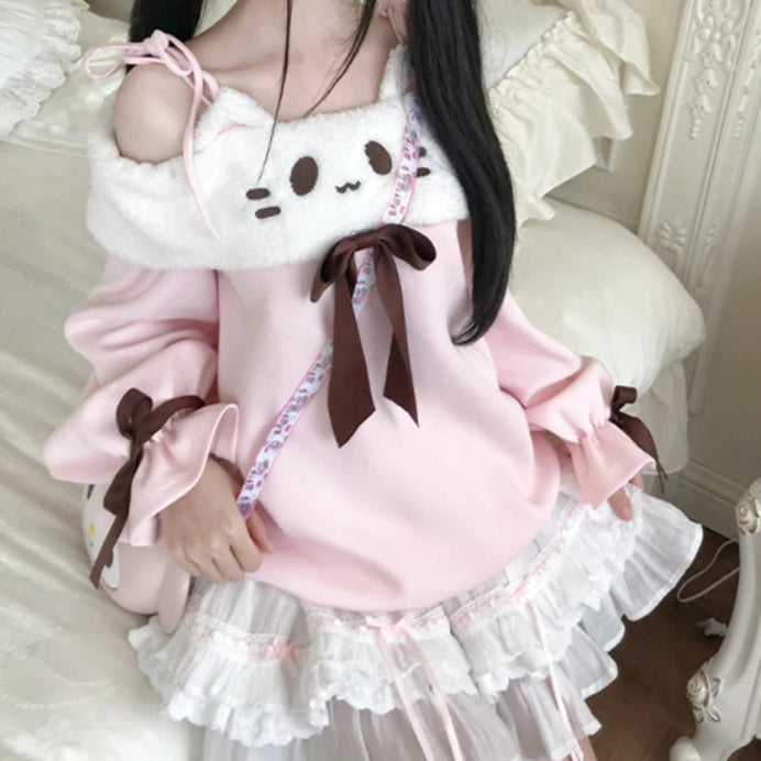Person wearing a pink and white outfit with ruffles in a decorative room.