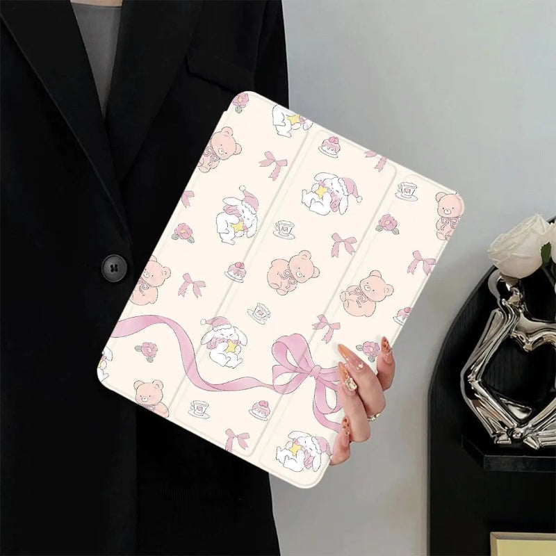 Person holding a tablet case with teddy bears and bows.