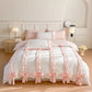 White duvet cover with pink bows and ribbons on a bed in a bedroom setting.