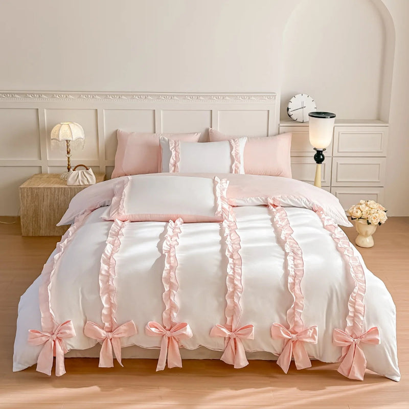 White duvet cover with pink bows and ribbons on a bed in a bedroom setting.