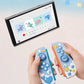 Two colorful gaming controllers held by hands with a screen displaying game graphics in the background.