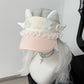 Pink visor with decorative elements on a mannequin head with white hair.