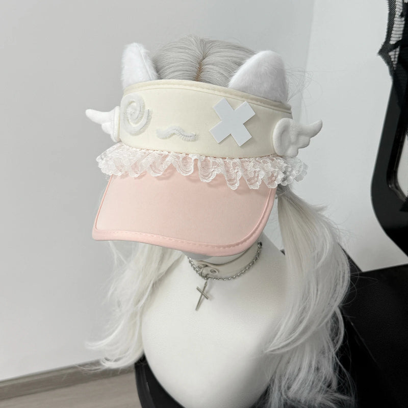 Pink visor with decorative elements on a mannequin head with white hair.