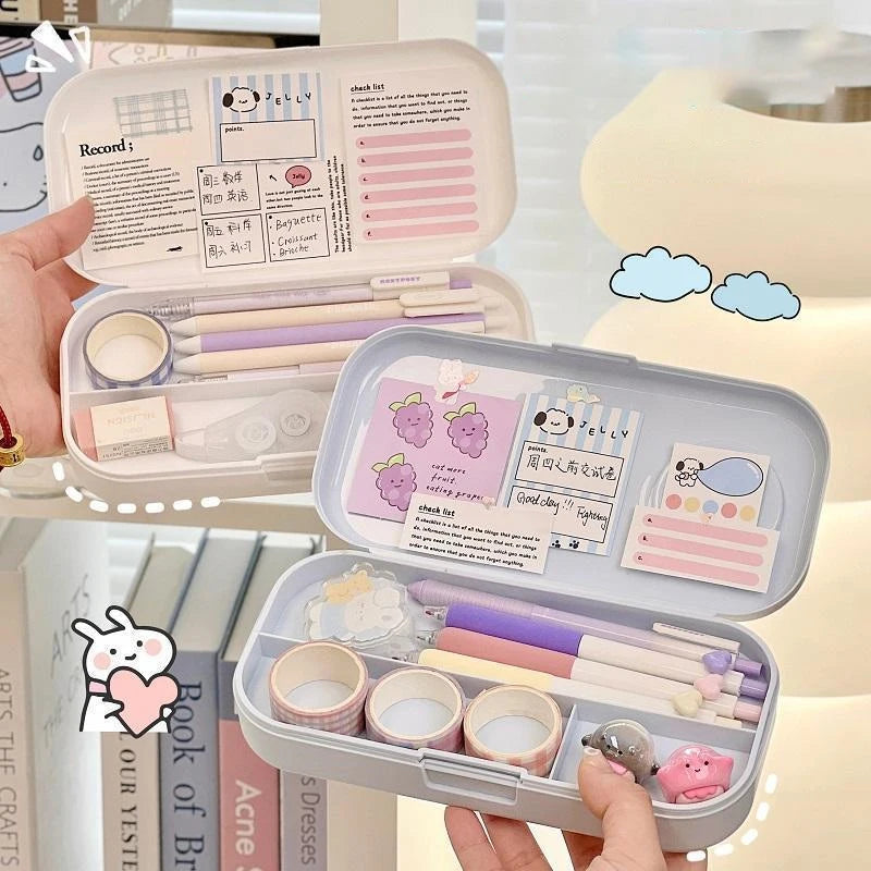 Small portable stationery set with stationery items in a clear case, held by a hand.