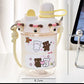  cute water bottle with cartoon designs held by hands against a blurred background. displaying the measurements of it.