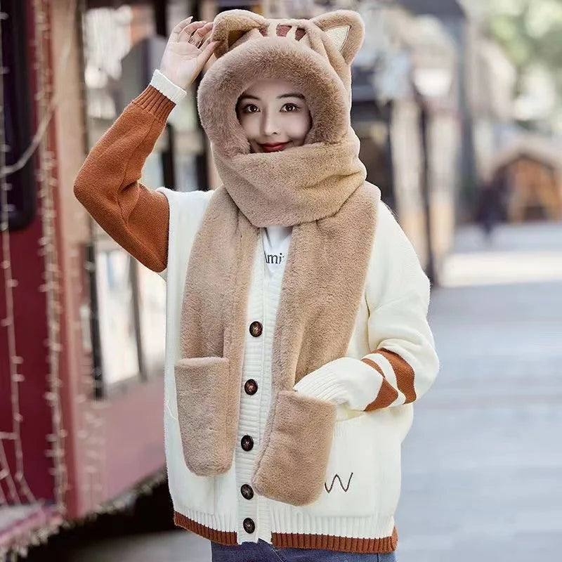 Person wearing a beige and brown cat hat and scarf on a blurred street background