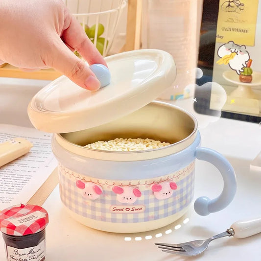 Cute ramen bowl with a lid on a table, filled with noodles.