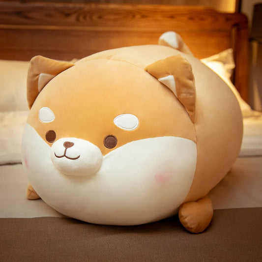 Cute plush toy shaped like a dog on a bed