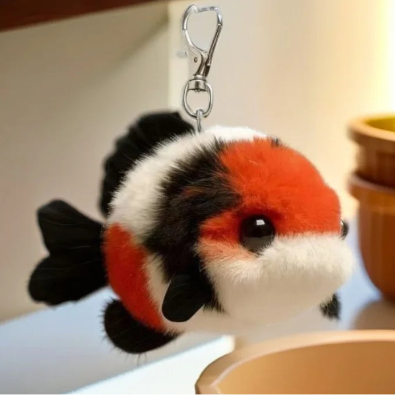 Plush koi fish keychain with a tag on a neutral background