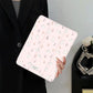 Person holding a pink tablet case with floral bunny design