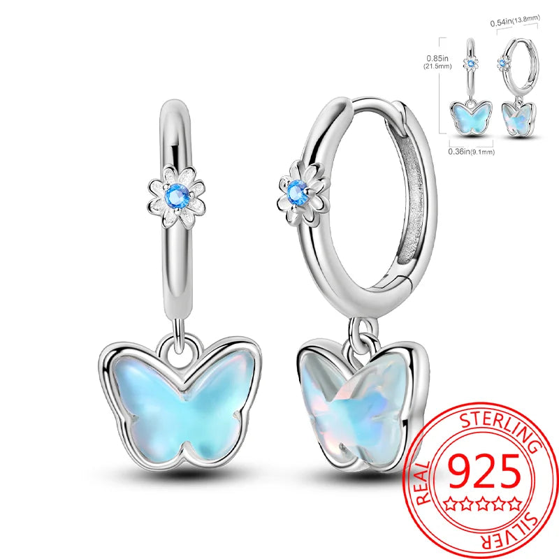 Butterfly earrings with blue gemstones on a white background, featuring a 'Real Sterling 925' stamp.