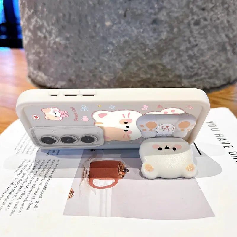 This women has position the phone into a stand position using the phone stand attached to the Kawaii Cuties Samsung Phone Case, showing a closer view of the design of the case which features a sweet cat and a bear as a phone stand, which also includes the mirror when you position its head a certain way.