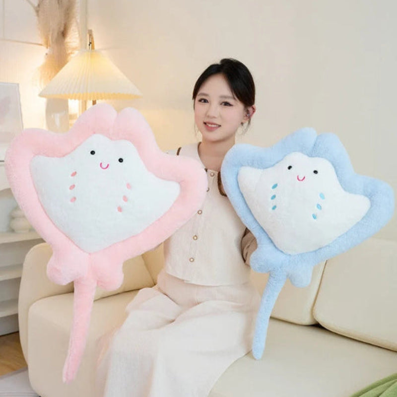 Woman hand holding Kawaii manta ray plushie