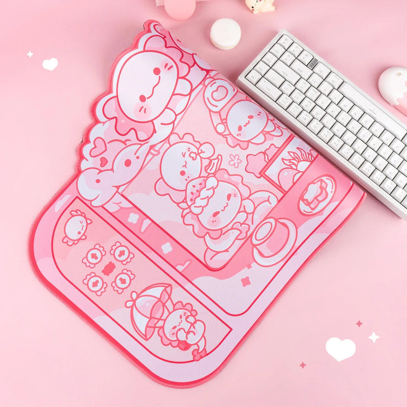 Pink cartoon axolotl themed mouse pad with a keyboard on a pink background
