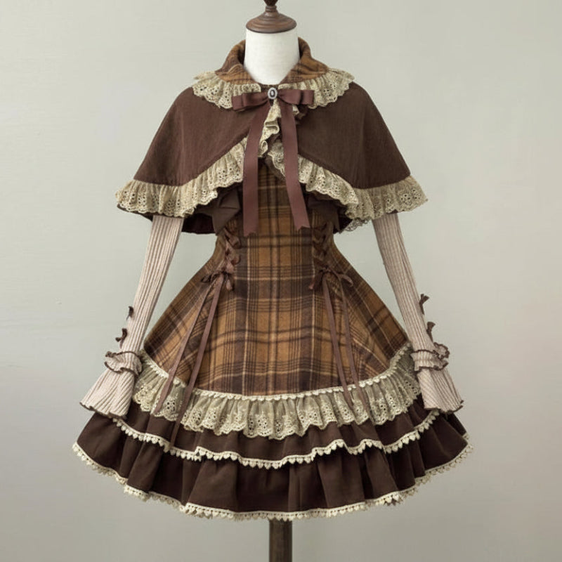 A brown and beige plaid Lolita-style dress displayed on a mannequin, featuring a matching brown cape with lace trim, striped sleeves, and a ruffled skirt.