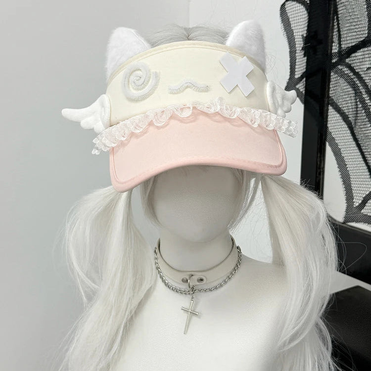 Mannequin head with a pink cap featuring white lace and decorative elements, wearing a white wig.