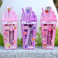 Three lip balm and lip gloss packages with colorful designs on a gray surface.