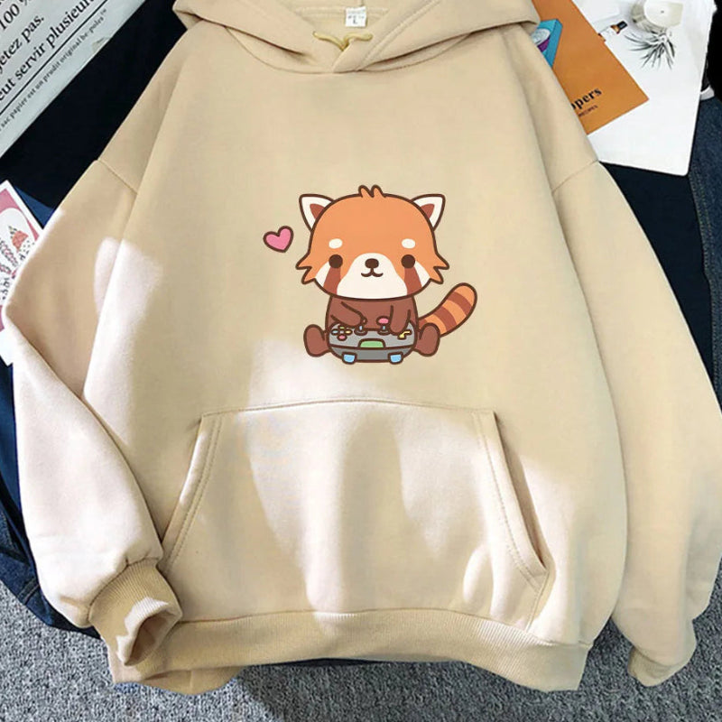 Beige hoodie with a red panda design on a surface with papers underneath