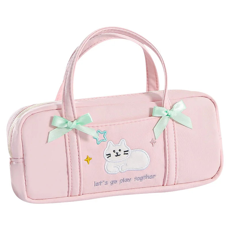 Pink pencil bag with a cat design and bows on a white background
