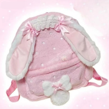 Pink backpack with bunny ears and bow on a light pink background