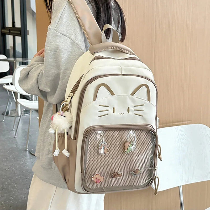 brown neko backpack displayed by person holding them.
