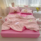 Pink seersucker duvet set displayed on bed.