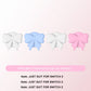 Four bow-shaped thumb grip caps in white, blue, and pink on a light pink background.