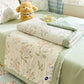 Kawaii Spring Quilts, the set being shown is the Cute Floral Deisgn with Green, displayed half open on a bed.