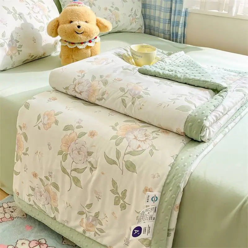 Kawaii Spring Quilts, the set being shown is the Cute Floral Deisgn with Green, displayed half open on a bed.