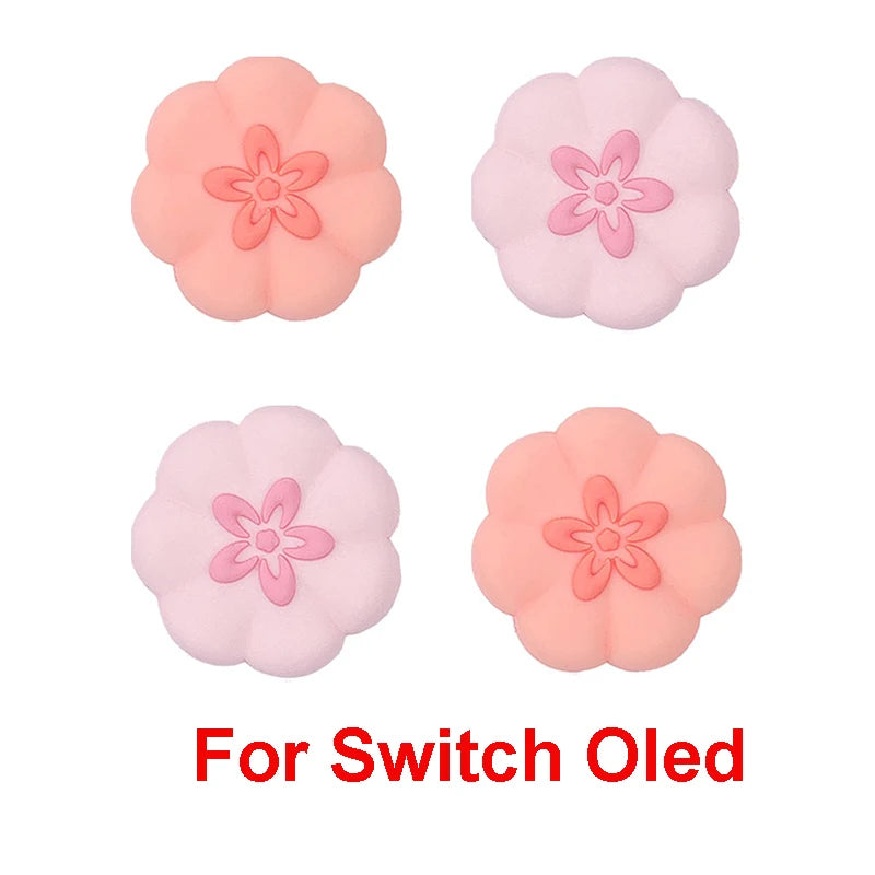 Four pink flower-shaped thumb grips for Switch OLED on a white background