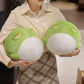 Woman holding two Kawaii round frog plushies
