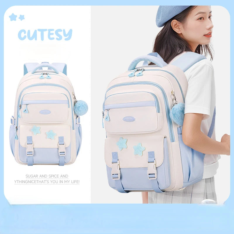 Cutesy backpack with star designs worn by a person on a light blue background