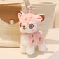 cute pink deer plushie keychain attached to a handbag